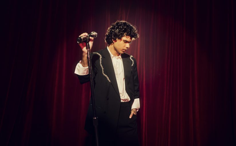 Budjerah on stage with a microphone